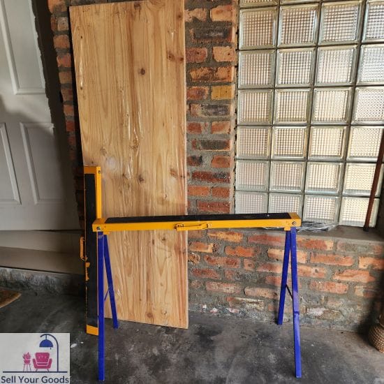 Two folding metal tressles with wooden top