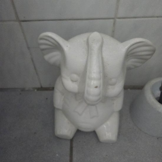 White ceramic elephant brush holder